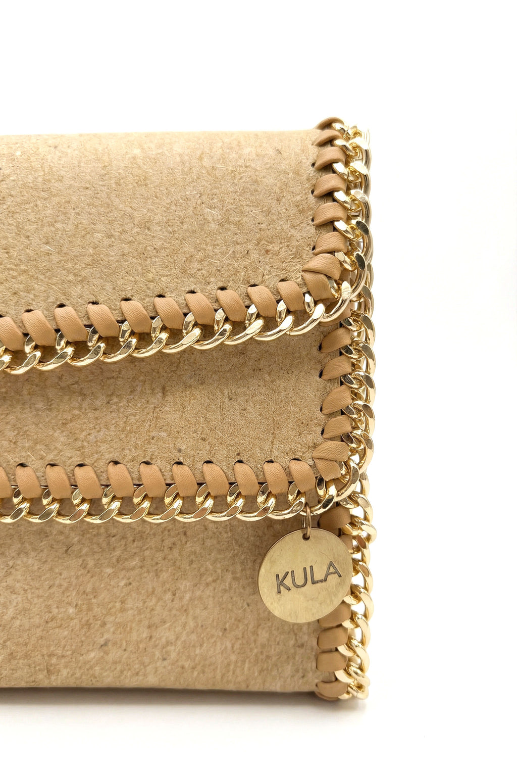 Beige handbag with gold chain detail and 'Kula' tag on a white background